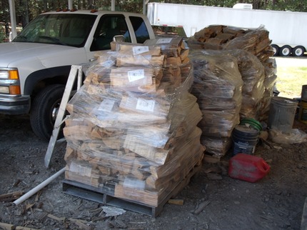Palates of bundled firewood, shrinkwrapped and ready to sell